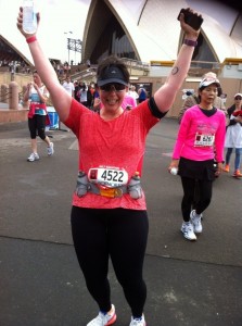Erin celebrates crossing the finishing line at the Sydney Marathon.