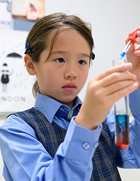 Pocket Rocket participant mixing solutions in test tube.