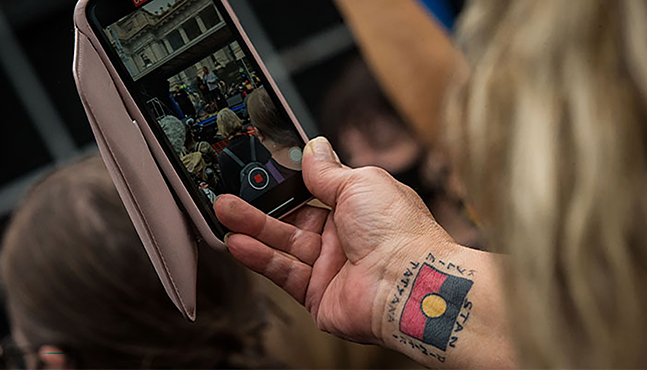 Indigenous activism - Indigenous person filming a rally