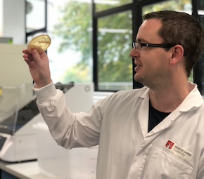 Roy Walker inspects petri dish