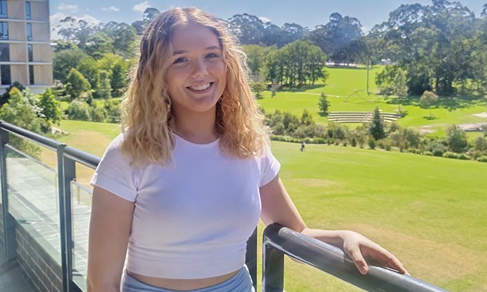 Danielle standing on campus smiling