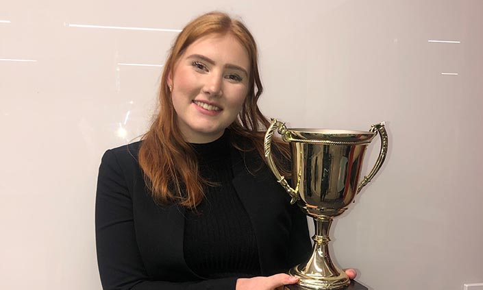 Taylor holding a trophy