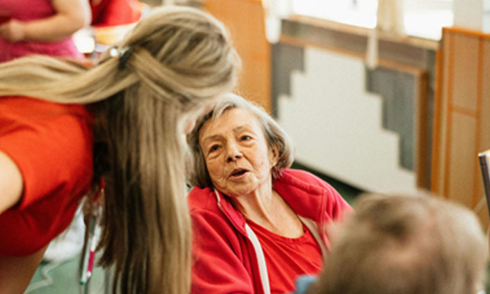 Someone speaking to an aged care resident.