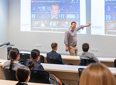 An academic giving a presentation at a school.