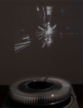 Projector displaying black and white video on wall