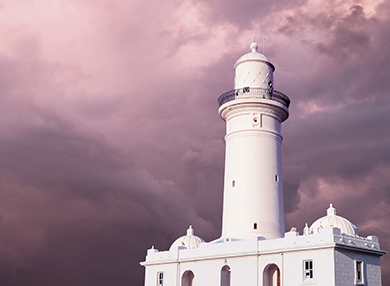The Macquarie Lighthouse against a background of purple clouds