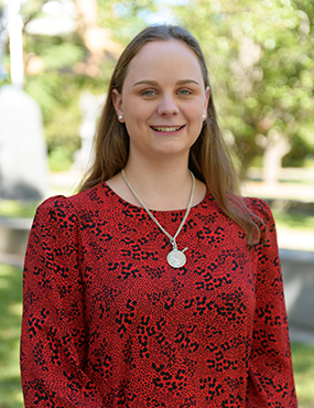 Edwina Keen, a 2019 University medallist wearing a red blouse and silver necklace.