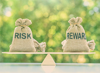 Two bags balanced on a scale, labelled 'risk' and 'reward' respectively