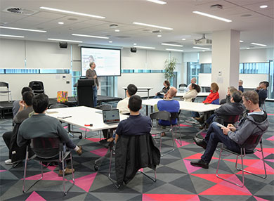 A group of people watching a lecture