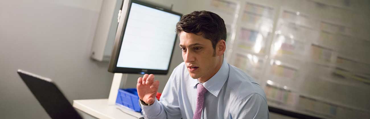 A person in a suit talking to someone off camera.