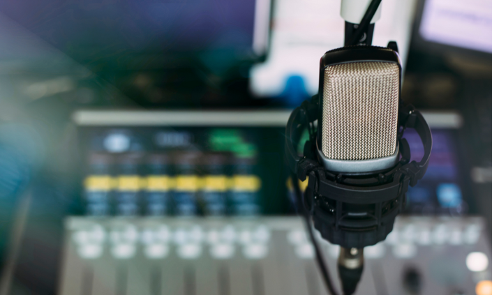 Photo of radio microphone with control panels in background