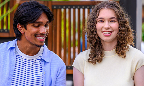 2 students smiling looking at the camera