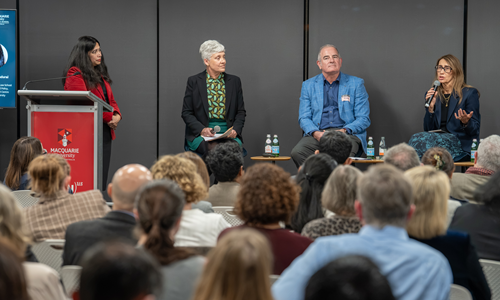 Panelists on stage with audience in the foreground
