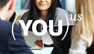 You to the power of Us written over a woman looking at a laptop