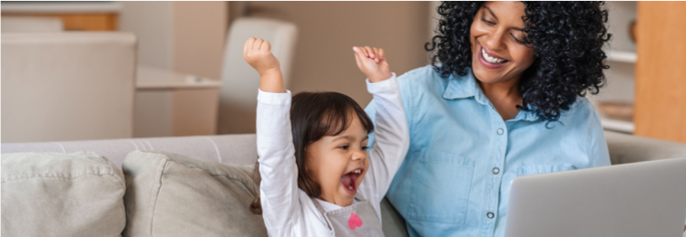 excited child with mum and laptop