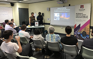 Speakers presenting to seated audience