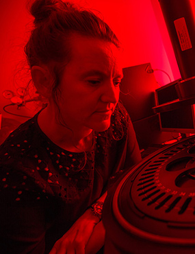 A woman looking at an artifact