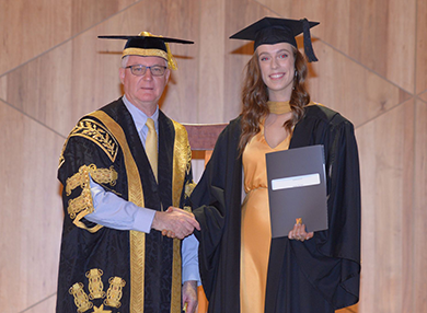 jade with chancellor at graduation ceremony