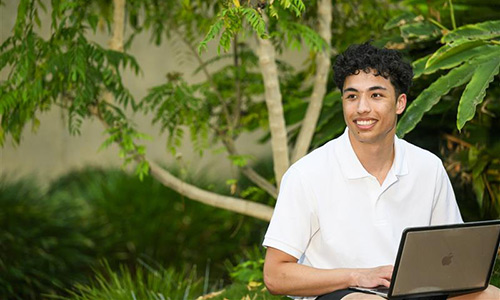A school student with a laptop.