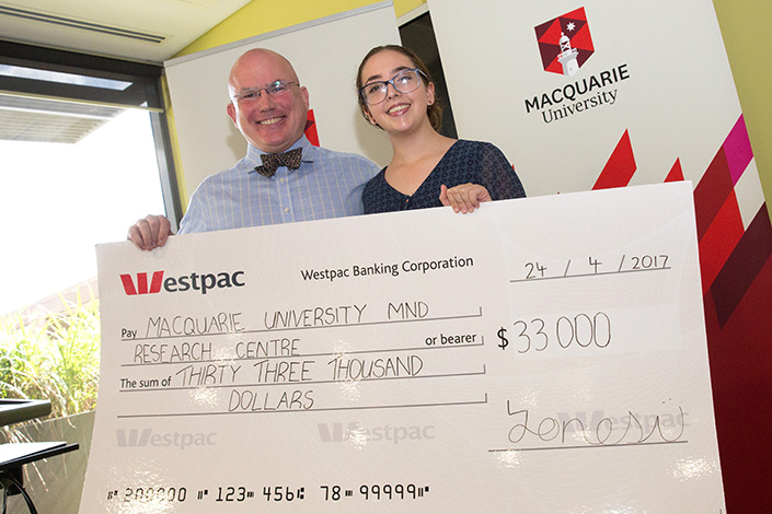 Juliette holding her $33000 fundraised cheque
