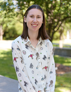 Laura Harris, a 2019 University medallist wearing a cream patterned shirt.