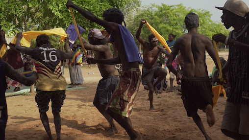 Photograph of Aboriginal men dancing at a funeral ceremony