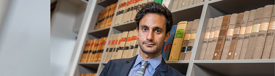 A man standing in front of a wall of books
