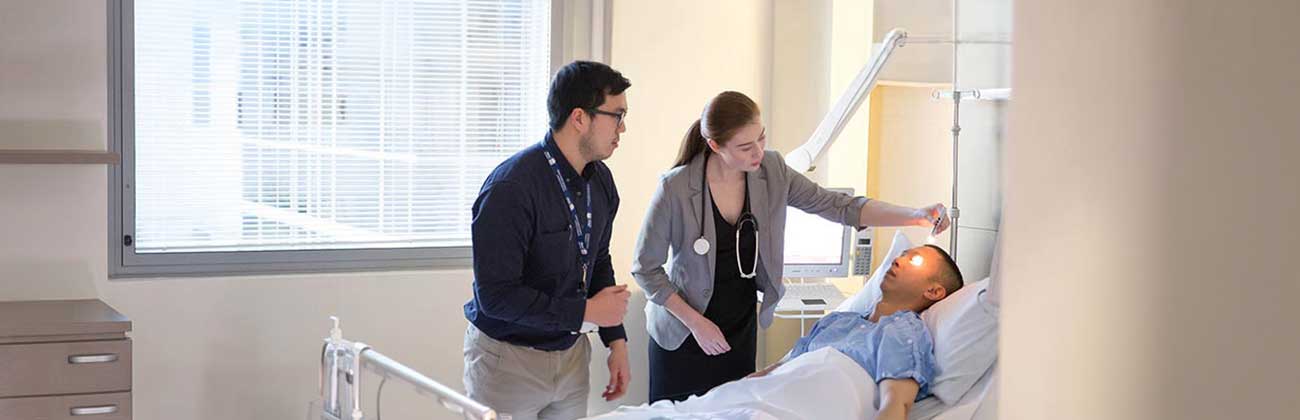 Two medical professionals observing a patient