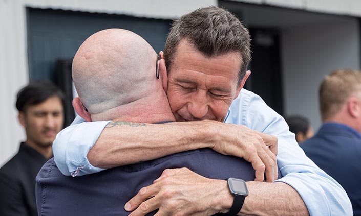 Two men hugging