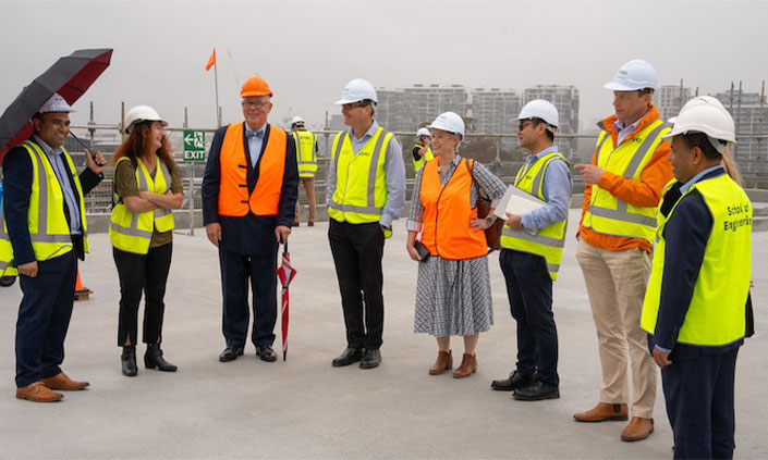 FDC Construction and MQ staff in high-vis on top of building