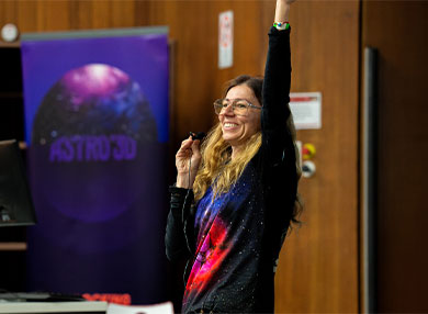 Lady giving lecture smiling with arm in the air