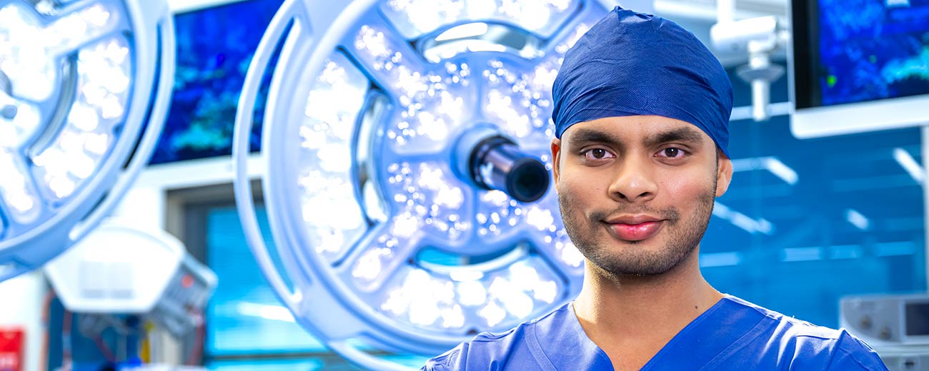 Doctor in an operating theatre looking at the camera