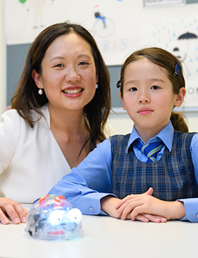 Dr Carol Newall sitting with Pocket Rocket participant.