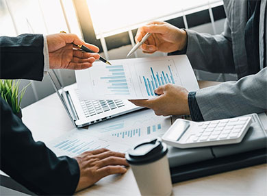 Two businessmen analysing a business report in an office