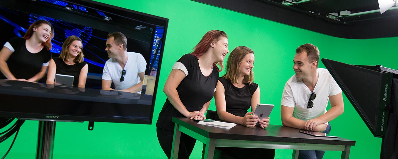 Students in the media facilities building with a green screen