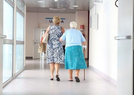 An old lady walking with another woman 