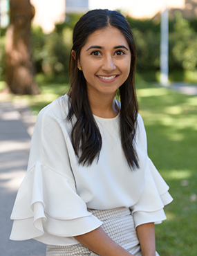Supreet Saluja, a 2019 University medallist wearing a cream blouse and check skirt.