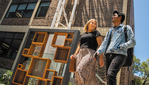 Two students walking on campus