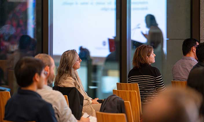 People on chairs watching a presentation