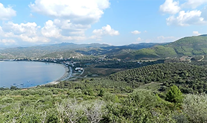 Landscape of bay with distant hills and trees in foreground