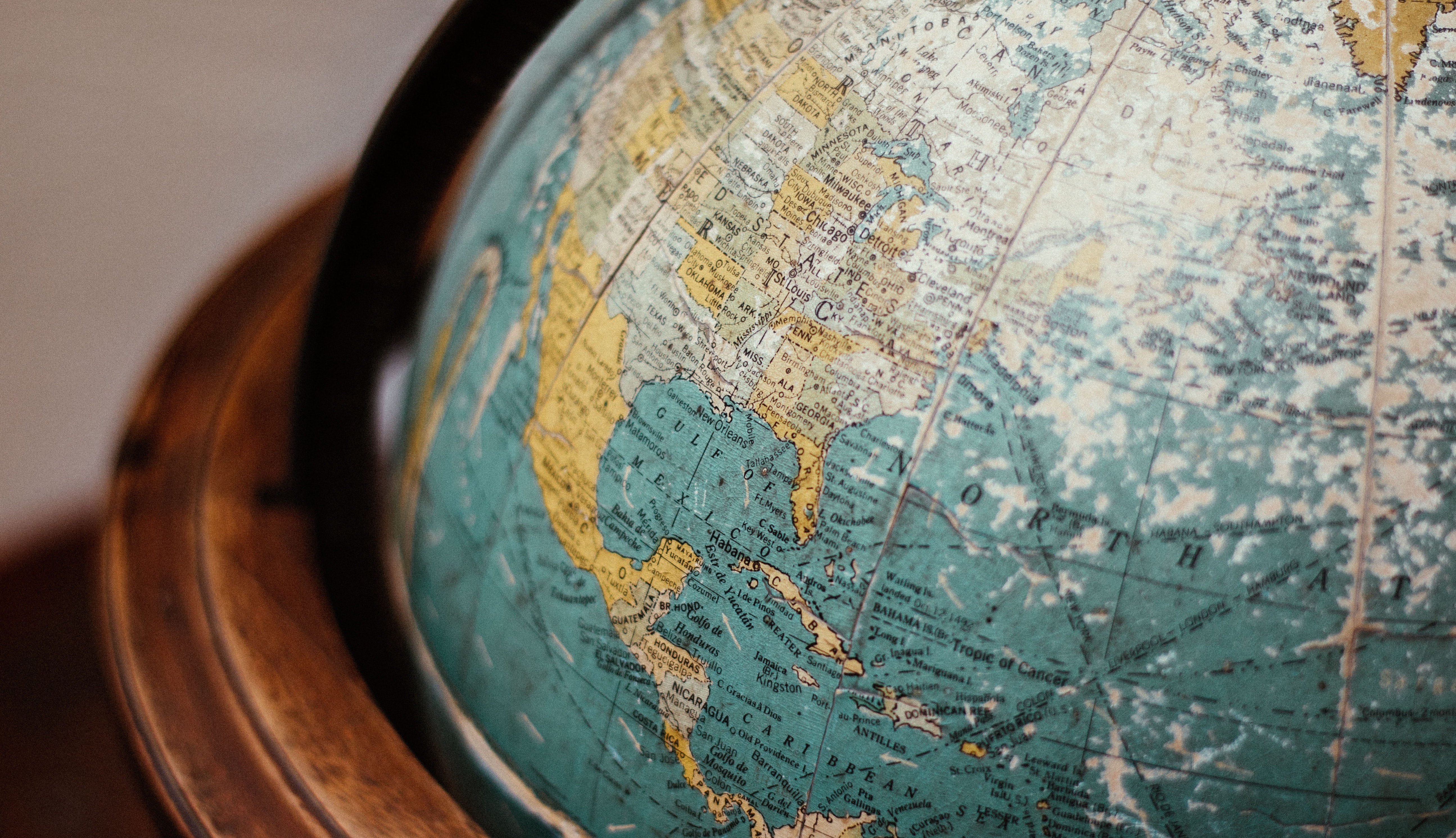 A close-up photo of a globe with a wooden frame.