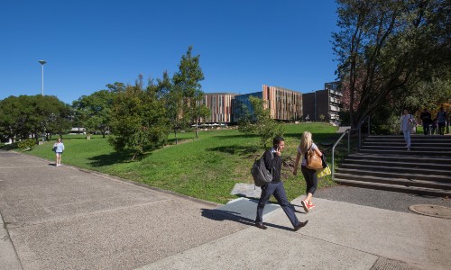 Two students walking on campus