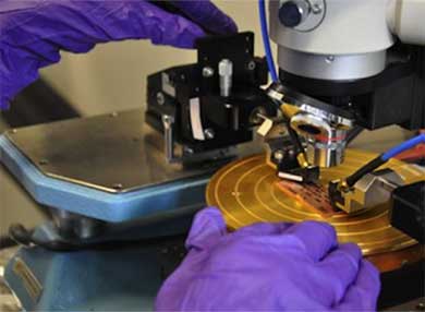 A researcher's hands working with a piece of technology