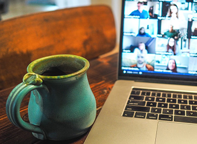 a mug and a laptop with a video chat open 