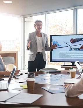 Woman in a corporate setting, delivering a presentation