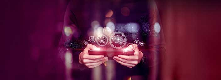 An animated image of a person holding a iPad with bubbles of images coming out of it