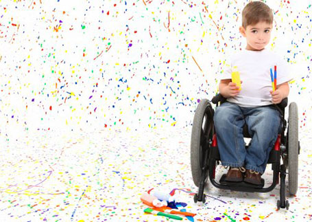 A boy in a wheelchair painting