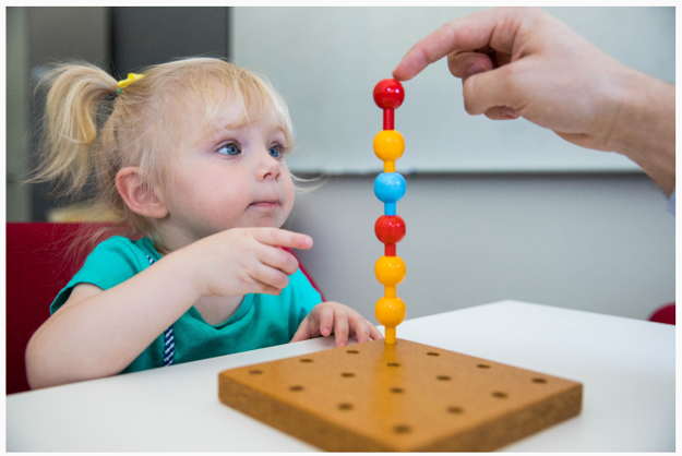 Girl pointing at pegs