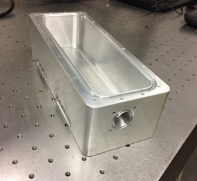 A laser box on a metal surface.