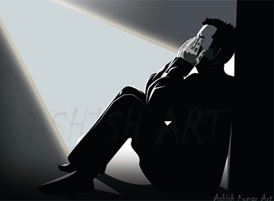 Black and white image of a man leaning on a wall while sitting on the floor with both hands covering his face